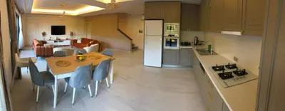 a kitchen and living room with a table and chairs at GateMaşukiye in Kartepe