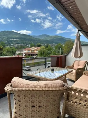 a patio with a table and chairs and a view at GateMaşukiye in Kartepe