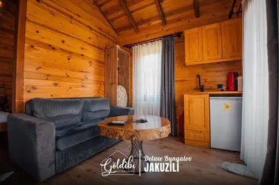 a living room with a couch and a coffee table at Sapanca Göldibi Suit Bungalov in Sakarya