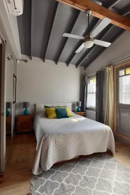 a bedroom with a bed and a ceiling fan at Golden Horn Views from The Saffron House in Old Istanbul in Istanbul
