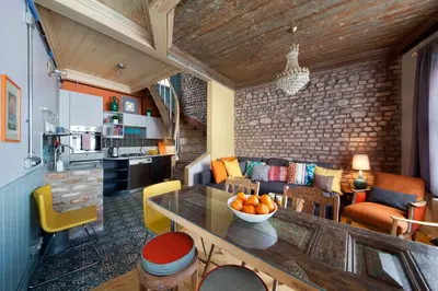 a kitchen and living room with a table and chairs at Enjoy Golden Horn views from Tangerine house in Istanbul
