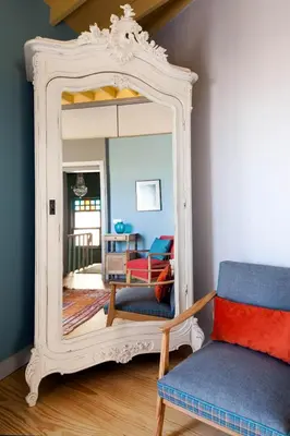 a mirror in a room with a couch and a chair at Enjoy Golden Horn views from Tangerine house in Istanbul