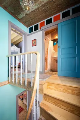a staircase in a house with a blue door at Enjoy Golden Horn views from Tangerine house in Istanbul