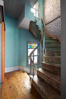 a staircase in a room with blue walls and wooden floors at Enjoy Golden Horn views from Tangerine house in Istanbul