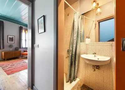 a bathroom with a sink and a mirror at Enjoy Golden Horn views from Tangerine house in Istanbul