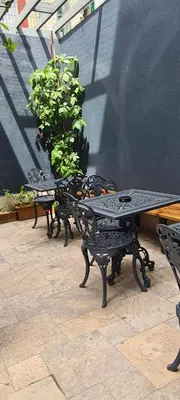 two benches and a table on a patio at Nostalgic & Comfortable Historical Home! in Istanbul