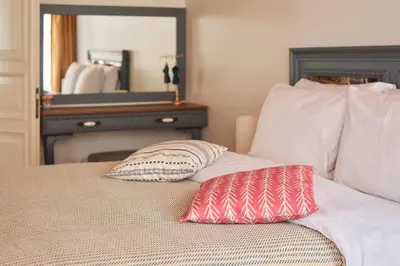 a bed with two pillows on it with a mirror at Nostalgic & Comfortable Historical Home! in Istanbul