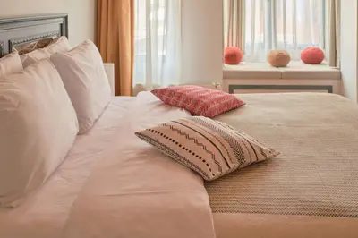 a white bed with two pillows on top of it at Nostalgic & Comfortable Historical Home! in Istanbul