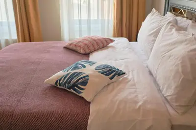 a bed with two pillows on top of it at Nostalgic & Comfortable Historical Home! in Istanbul