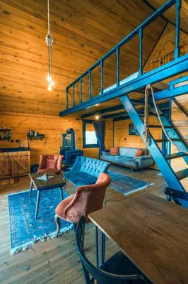 a living room with a blue couch and a staircase at Sapanca Kırsal Silence in Sapanca