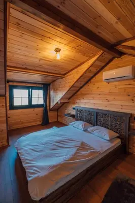 a bedroom with a bed in a wooden cabin at Sapanca Kırsal Silence in Sapanca