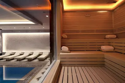a sauna with chairs and a swimming pool at Lazzoni Hotel in Istanbul