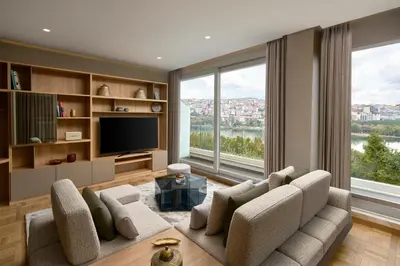 a living room with a couch and a tv at Lazzoni Hotel in Istanbul