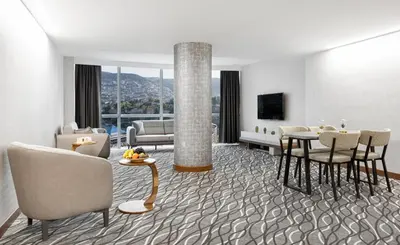 a living room with a couch and a table and chairs at Lilium Hotel & Suites in Bursa
