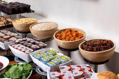 a table with different types of food in bowls at Great Fortune Concept Hotel in Istanbul