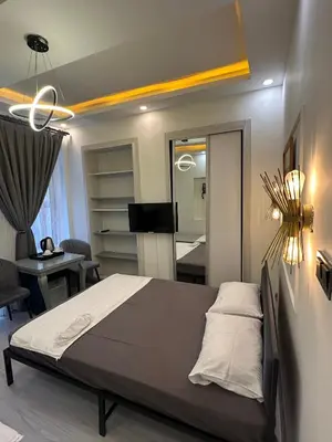 a bedroom with a bed and a living room at Moon suit in Istanbul