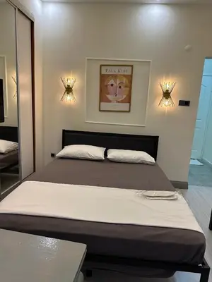 a large bed in a bedroom with two lights at Moon suit in Istanbul