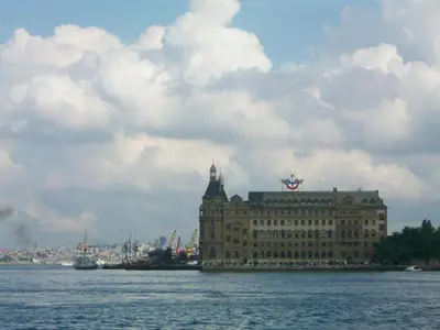 a building with a flag on top of it on the water at Hotel Acar in Istanbul
