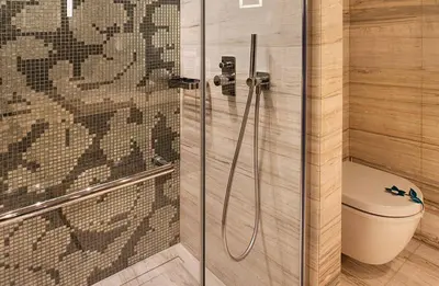 a bathroom with a toilet and a glass shower at Fer Hotel in Istanbul