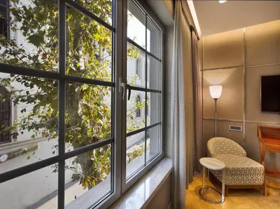 a room with a window and a chair and a desk at Fer Hotel in Istanbul