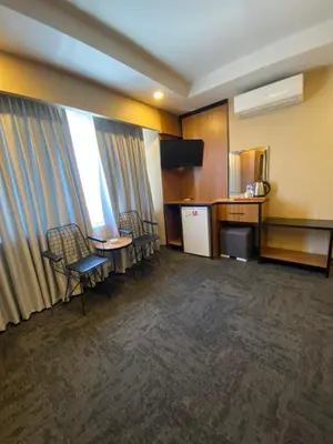 a room with chairs and a table and a kitchen at Green Palmiye Hotel in Avcılar