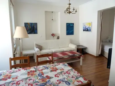 a living room with a couch and a table at Super Location Cosy Apartment TaximHome 3 at Taksim Cihangir in Istanbul