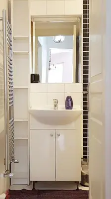 a white bathroom with a sink and a mirror at Super Location Cosy Apartment TaximHome 3 at Taksim Cihangir in Istanbul