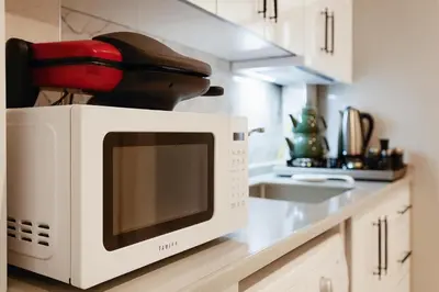 a white microwave on a counter in a kitchen at Casa Florya Suites in Istanbul