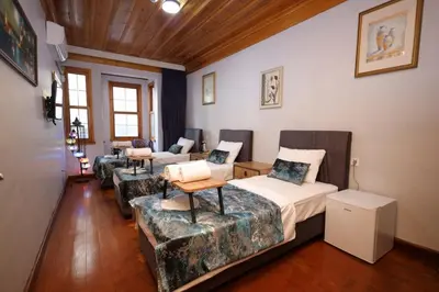 a room with two beds and couches in it at The Trip Anex Hotel in Istanbul