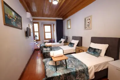a room with two beds and a couch at The Trip Anex Hotel in Istanbul
