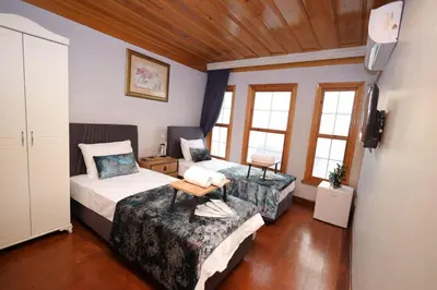 two beds in a room with two windows at The Trip Anex Hotel in Istanbul