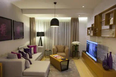a living room with a couch and a tv at The Leos Residence in Istanbul