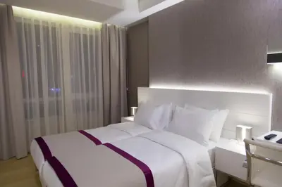 a bedroom with a white bed and a window at The Leos Residence in Istanbul