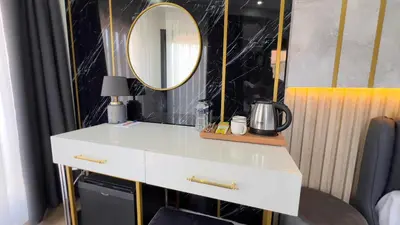 a bathroom with a white vanity and a mirror at Madrigal Boutıque Hotel in Istanbul
