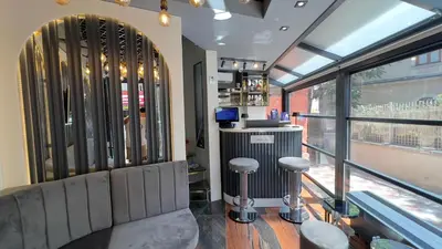 a bar with stools in a room with a window at Madrigal Boutıque Hotel in Istanbul