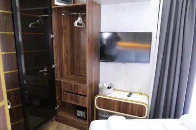 a room with a tv and a bed and a door at Madrigal Boutıque Hotel in Istanbul