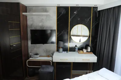 a bedroom with a white desk and a tv at Madrigal Boutıque Hotel in Istanbul
