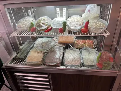 a refrigerator filled with different types of food at Çiğdem Motel Pansiyon & PUB in Termal