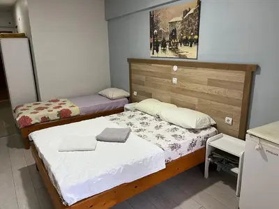 a small room with two beds and a desk at Çiğdem Motel Pansiyon & PUB in Termal