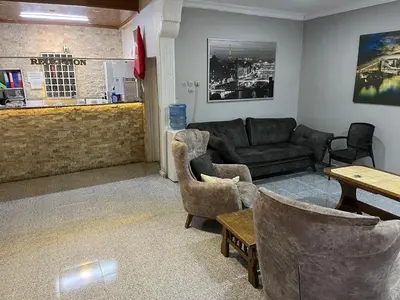 a living room with a couch and chairs and a table at Çiğdem Motel Pansiyon & PUB in Termal
