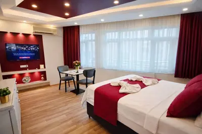 a bedroom with a bed and a table and a tv at Valentina Apart Hotel in Istanbul