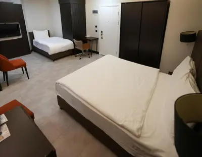 a hotel room with a bed and a desk and a bedroom at Visse Hotel in Mudanya