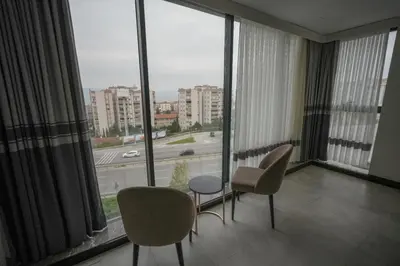 a room with two chairs and a table and a large window at Visse Hotel in Mudanya
