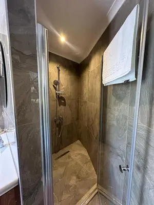 a shower with a glass door in a bathroom at Kalimeras Deluxe Hotel in Sapanca