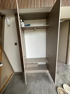 ajar view of a closet with white cabinets at Kalimeras Deluxe Hotel in Sapanca