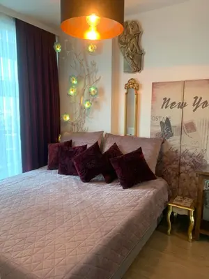a bedroom with a large bed with purple pillows at İstanbul Ataköy Residance Bakırköy Site İçi luxury daire in Istanbul
