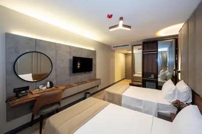 a hotel room with two beds and a mirror at Vess Hotel in Istanbul