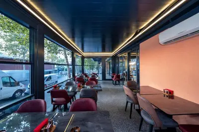 a restaurant with tables and chairs and windows at Vess Hotel in Istanbul