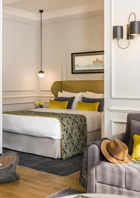 a hotel room with two beds and a couch at Nevv Bosphorus Hotel & Suites in Istanbul
