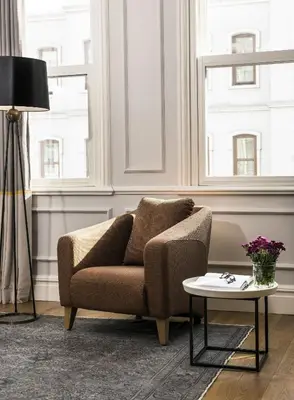 a living room with a couch and a table at Nevv Bosphorus Hotel & Suites in Istanbul